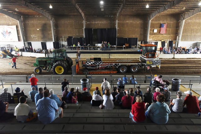 Travis Jensen, of Dowagiac, Mich., finishes in first place, driving a John Deere 4640 in the 18,000 pound weight class division, during a farm tractor pulling competition, Aug. 14, 2023, at the Berrien County Youth Fair in Berrien Springs, Mich.
