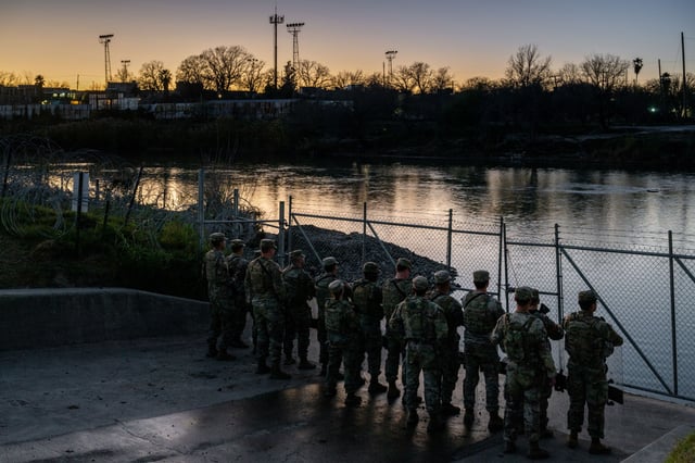 National Guard soldiers stand guard on the banks of the Rio Grande river at Shelby Park on January 12, 2024 in Eagle Pass, Texas.