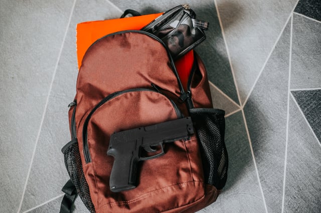 backpack with notebook and handgun