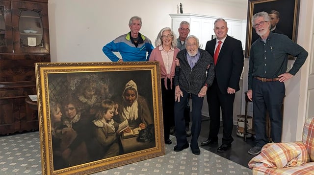 Special Agent Gary France, second right,, Dr. Francis Wood and Wood’s children stand next to the John Opie painting that was stolen from Wood’s parents' home in 1969 in Newark, N.J.,on Thursday, Jan. 11, 2024. The 18th-Century John Opie painting stolen by mobsters in 1969 with help from a New Jersey state lawmaker has been returned more than 50 years later, the FBI’s Salt Lake City field office announced Friday, Jan. 26.