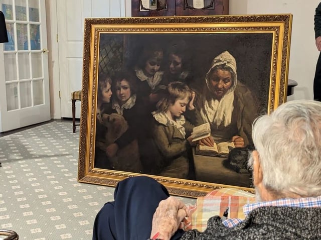 Dr. Francis Wood, 96, admires the John Opie painting, "The Schoolmistress", stolen from his parents' Newark, New Jersey home in 1969 and recently returned to him as the rightful owner.