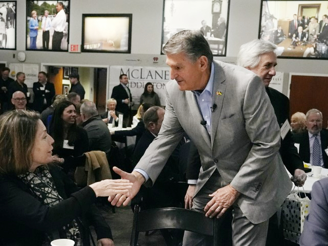 Sen. Joe Manchin (D-WV) shakes hands with guests during the 'Politics and Eggs' event, as part of his national listening tour, Friday, January 12, 2024, in Manchester, New Hampshire. Sen. Manchin announced last November that he would not seek reelection in 2024 and has teased a potential third-party run for the presidency. (Charles Krupa/AP)