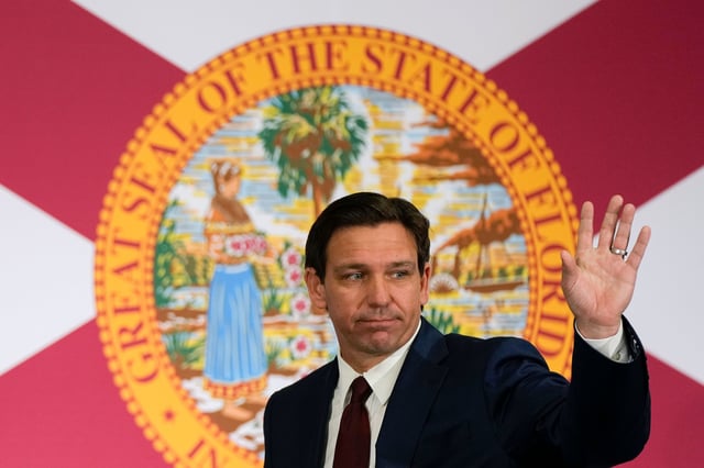 Florida Governor Ron DeSantis waves as he leaves after signing several bills in Miami on Tuesday.