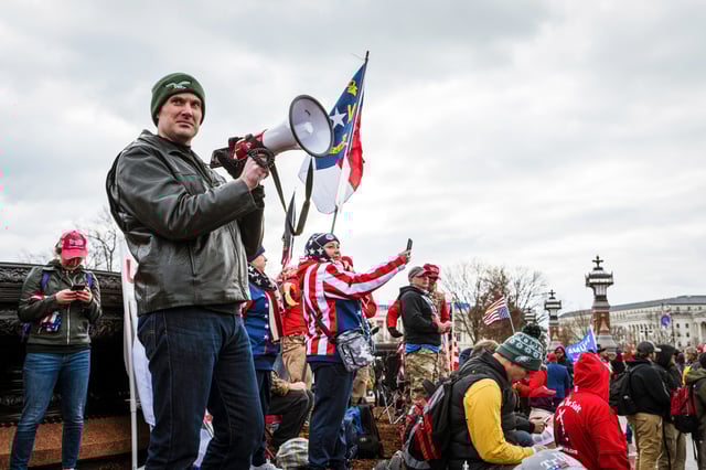 A pro-Trump protester leads a crowd in a chant with a megaphone in front of the Capitol Building on Jan. 6, 2021.