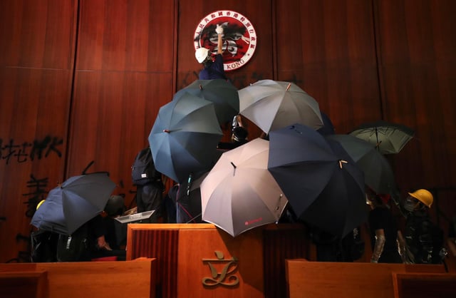 Protesters deface the city’s emblem in the Legislative Council chamber during the 2019 anti-government protests. Photo: Sam Tsang