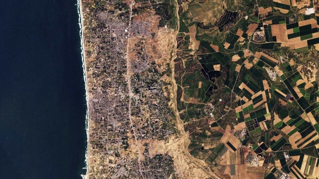 This satellite photo from Planet Labs PBC shows the Gaza Strip on Tuesday, Jan 30, 2024. Satellite photos show new demolition along a 1-kilometer-deep path on the Gaza Strip's border with Israel, according an analysis by The Associated Press and expert reports. The destruction comes as Israel has said it wants to establish a buffer zone there, further tearing away at land the Palestinians want for a state over international objections. (Planet Labs PBC via AP)