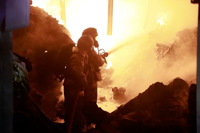 Firefighters put off a fire caused by an explosion at an industrial building in Nairobi, Kenya Friday, Feb. 2, 2024. Gas explosions at an industrial building in Kenya's capital injured more than a dozen of people and sent a fiery smoke plume rising over homes early Friday, authorities said.