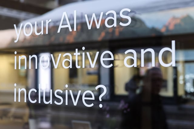A sign on a window reading “Your AI Was Innovative And Inclusive?” is seen on day three of the World Economic Forum in Davos, Switzerland, on January 18, 2024. Photo: Bloomberg