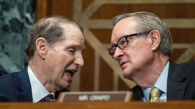 Senate Finance Committee Chairman Ron Wyden speaks with Sen. Crapo during a 2023 hearing. Senate Republicans are not on board with the bipartisan tax bill that passed, angry that they were cut out of negotiations between Finance Committee Chairman Ron Wyden and Ways and Means Committee Chair Jason Smith.