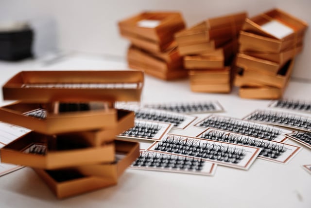 Packs of false eyelashes on a table at a workshop in China’s Shandong province in November. Photo: Reuters