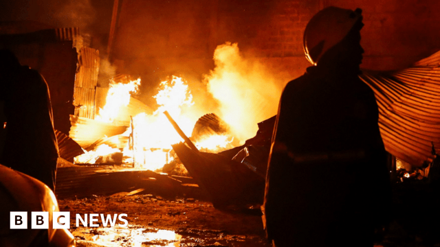 A firefighter gathers at the scene of an explosion at a makeshift gas cylinder refilling depot in Mradi estate, Embakasi district of Nairobi