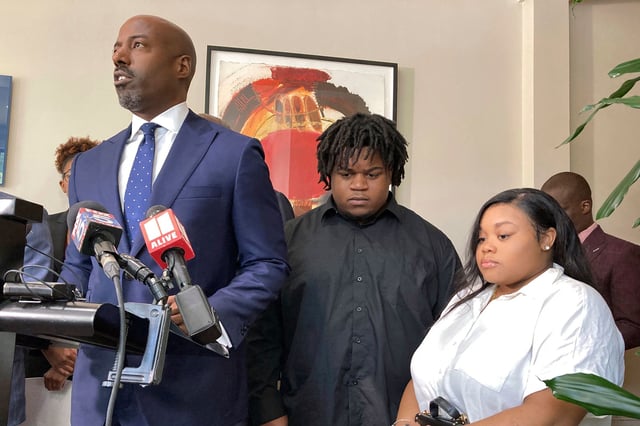 Attorney Cory Lynch, left, joined by Treveon Isaiah Taylor, Sr., Jessica Ross, speaks during a news conference in August 2023 in Atlanta.