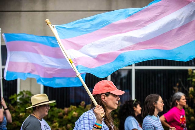A woman attends a rally in support of trans youth in schools on June 26, 2023, outside the Fayette County Public Schools central office in Lexington, Ky.