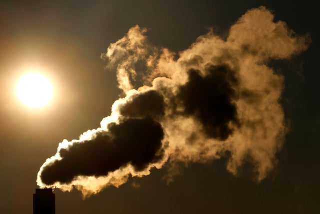 NEWARK, NJ - JANUARY 21: An emission comes out of a smoke stack at the Essex County Resource Recovery Waste-to-Energy Facility as the sun rises on January 21, 2024, in Newark, New Jersey.  (Photo by Gary Hershorn/Getty Images)