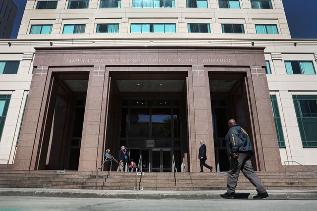 A member of the US Marshals Service walks in front of the federal district court in Miami, Florida in 2018.