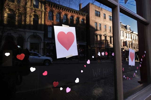 Valentine's Day Hearts decorate a storefront on Exchange Street, Wednesday, Feb. 14, 2024, in Portland, Maine. The public has helped honor the memory of Kevin Fahrman, the Valentine's Day Bandit who secretly hung hundreds of red paper hearts throughout the city every February 14th. Farman died last year.