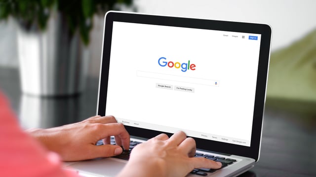 A person at a laptop Googling