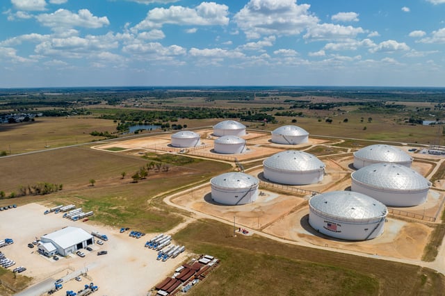 In an aerial view, oil storage tanks at the Enterprise Sealy Station are seen on August 28, 2023 in Sealy, Texas.
