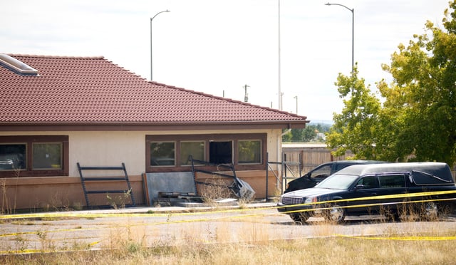 A hearse and van sit outside the Return to Nature Funeral Home, Oct. 6, 2023, in Penrose, Colo.