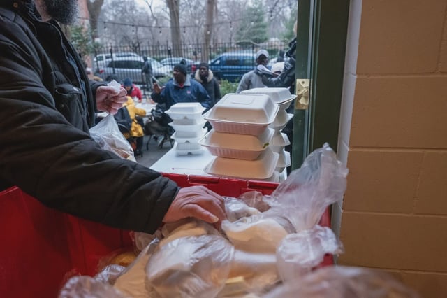 Volunteers hand out meals at Trinity Services and Food For the Homeless