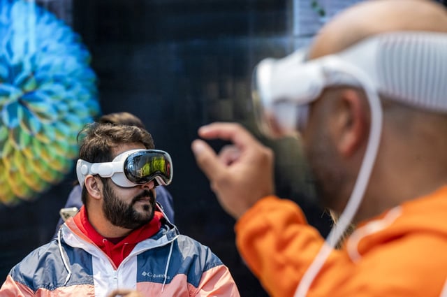 A customer with an Apple Vision Pro mixed reality (XR) headset at the company's store in Palo Alto, Calif., on Feb. 2, 2024.