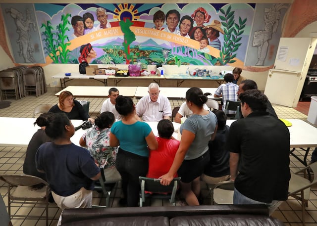 Ruben Garcia, director of the Annunciation House, speaks with migrant parents on June 26, 2018, in El Paso, Texas.