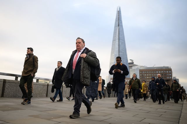 LONDON, UNITED KINGDOM - JANUARY 31: The Shard is seen on the horizon as commuters cross London Bridge during the morning rush hour on January 31, 2023 in London, United Kingdom. The IMF reports that the UK economy will contract by 0.6% in 2023, as opposed to the previous prediction it might grow, and will perform worse than many other advanced economies, including Russia.The cost of living continues to hit households with grocery inflation for the first four weeks of 2023 rising to 16.7% which would add a further Â£788 per year to family food bills. (Photo by Leon Neal/Getty Images)