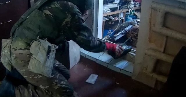 A screengrab from video footage obtained by Reuters shows a fighter from the BARS 9 volunteer force of the Russian military playing with a toy tank he found in an apartment in Balakliia, eastern Ukraine, September 7, 2022. Video obtained by REUTERS 