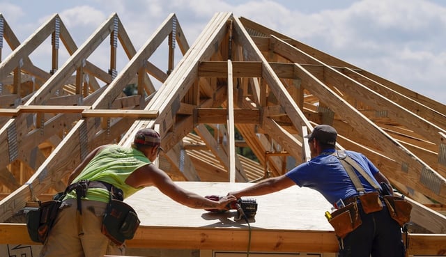 Business economists expect more economic growth and a soft landing. Workers build a home Tuesday, Sept. 19, 2023, in Marshall, N.C. Climate change is increasing billion-dollar disasters, many of them from intensifying hurricanes. Housing developers are now building homes, some of them round, that can resist hurricane-force winds and at the same time generate much less of the emissions that contribute to climate change.