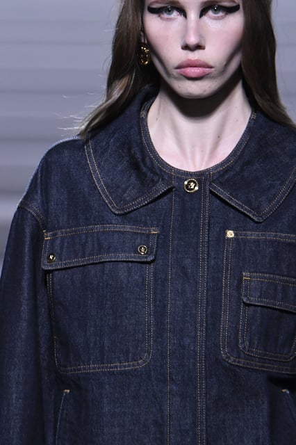 A focus on dark tones also extended to denim (above, at Versace), where deep washes and clean cuts were the order of the season.