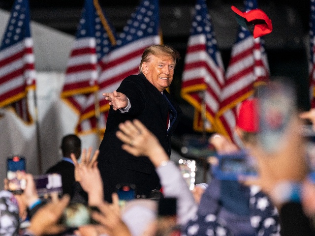 Former U.S. President Donald Trump tosses a hat into the crowd at a 'Save America' rally in Commerce, Georgia, U.S., on Saturday, March 26, 2022. Trump is focusing most of his ire over losing the 2020 election on Georgia, where he will put his status as a GOP kingmaker on the line on Saturday to turn voters against the states Republican governor and other party incumbents. Photographer: Elijah Nouvelage/Bloomberg via Getty Images
