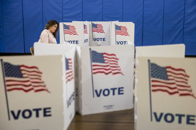 HERNDON, VA - MARCH 03: A woman marks down her vote on a ballot for the Democratic presidential primary election at a polling place in Armstrong Elementary School on Super Tuesday, March 3, 2020 in Herndon, Virginia. 1,357 Democratic delegates are at stake as voters cast their ballots in 14 states and American Samoa on what is known as Super Tuesday. (Photo by Samuel Corum/Getty Images)
