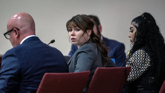 Hannah Gutierrez-Reed, center, sits with her attorney Jason Bowles, left, during the first day of testimony in the trial against her in First District Court, in Santa Fe, N.M., Thursday, February 22, 2024. Gutierrez-Reed, who was working as the armorer on the movie "Rust" when a revolver actor Alec Baldwin was holding fired killing cinematographer Halyna Hutchins and wounded the film’s director Joel Souza, is charged with involuntary manslaughter and tampering with evidence.