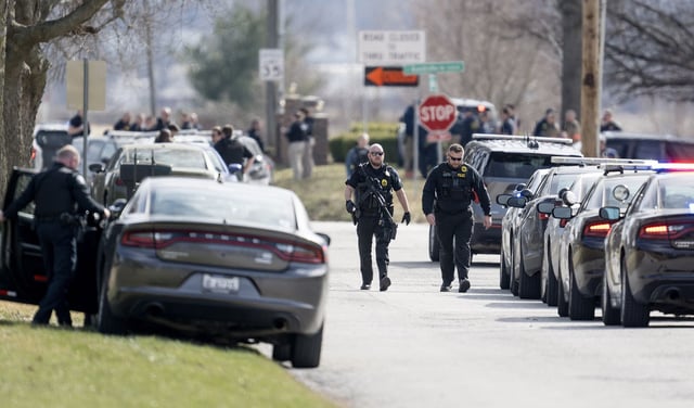 Law enforcement officials and medical personnel work the scene of an officer involved shooting near the intersection of Elsea Smith Road and Budschu Road on Thursday, Feb. 29, 2024, in Independence, Missouri. (Nick Wagner/The Kansas City Star/Tribune News Service via Getty Images)