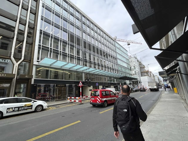 FILE - A man walks past the building where is located the Gunvor trading office in Geneva, Switzerland, Wednesday July 26, 2023. Geneva-based commodities trading firm Gunvor said Friday, March 1, 2024, that it has reached a $661 million settlement with U.S. and Swiss prosecutors after convictions for bribery of foreign officials in connection with the petroleum industry in Ecuador.