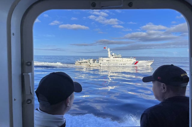 FILE - A Chinese coast guard vessel maneuvers beside the Philippine coast guard ship BRP Cabra as they approach the Second Thomas Shoal, locally known as Ayungin Shoal, during a resupply mission on the disputed South China Sea on Nov. 10, 2023. Chinese coast guard ships blocked Philippine vessels from a disputed South China Sea shoal Tuesday, March 5, 2024, causing a minor collision, Philippine officials said.