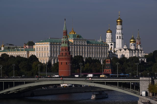 A tourist boat sails on the Moskva river in front of the Kremlin in Moscow on September 19, 2023.