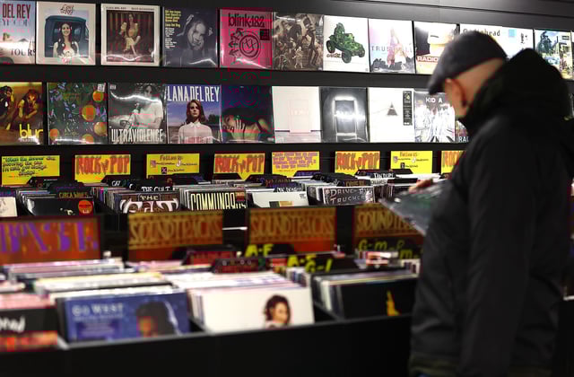 LONDON, ENGLAND - DECEMBER 28: A customer looks through a rack of vinyl records at the HMV store on Oxford street on December 28, 2023 in London, England. The British Phonographic Industry figures show UK vinyl sales rose by 11.7% to 5.9 million units this year, increasing for the 16th year in a row. Taylor Swift's 1989 (Taylor's version) was the best-selling LP and she has two further albums in the top 10. (Photo by Peter Nicholls/Getty Images)