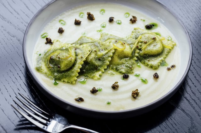 Celery root ravioli with caper, basil pesto and garlic-parmesan emulsion photographed at 7 Adams in San Francisco. The restaurant will be added to the Michelin Guide this year.