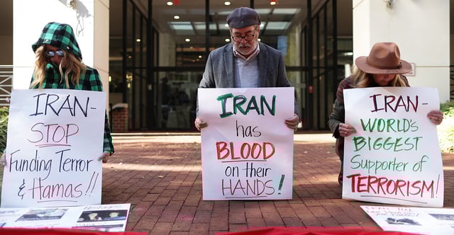 The Biden administration's renewal of a sanctions waiver allows Iran access to $10 billion in frozen funds, sparking criticism for concessions and a soft-line stance. Pictured: The Rev. Patrick Mahoney, director of the Christian Defense Coalition, leads a prayer Nov. 1 during a demonstration outside the Interests Section of Iran in Washington, D.C. (Photo: Alex Wong/Getty Images)