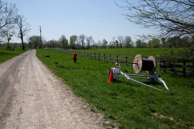 Broadband is installed in Kentucky. Dave Wallace, an employee of Silica Broadband, pulls fiber to install internet in Louisville, Kentucky, U.S., April 19, 2021.