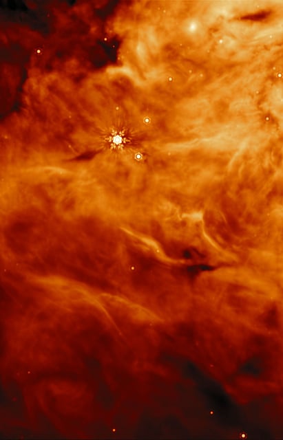 This image was taken by Webbâs Mid-InfraRed Instrument (MIRI) of a region parallel to the massive protostar known as IRAS23385.Â  IRAS 2A and IRAS23385 (not visible in this image) were targets for a recent research effort by an international team of astronomers that used Webb to discover that the key ingredients for making potentially habitable worlds are present in early-stage protostars, where planets have not yet formed. With MIRIâs unprecedented spectral resolution and sensitivity, the JOYS+ (James Webb Observations of Young ProtoStars) programme individually identified organic molecules that have been confirmed to be present in interstellar ices. This includes the robust detection of acetaldehyde, ethanol, methyl formate, and likely acetic acid, in the solid phase. [Image description: A region of a molecular cloud. The cloud is dense and bright close to the top of the image, like rolling clouds, and grows darker and more wispy towards the bottom and in the top corner. One bright star, and several dimmer stars, are visible as light spots among the clouds. The image is a single exposure which has been assigned an orange colour for visibility.]