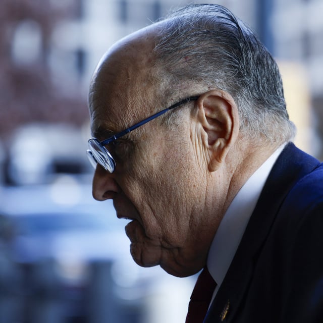 Above, a photo of Rudy Giuliani leaving court in Washington, D.C., on December 15, 2023. A creditor organization has filed a motion seeking to compel the former NYC mayor to sell a Florida condo in order to pay off part of his defamation penalty.