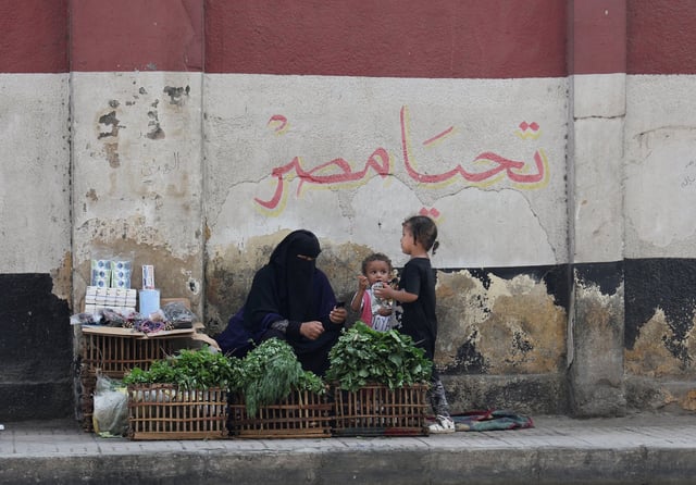 A woman street vendor and her children wait for customers in Cairo in October 2023. Inflation has been running close to record highs and many Egyptians say they struggle to get by. Photo: Reuters