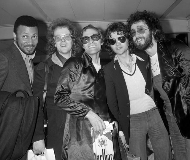 Steve Harley, center, and Cockney Rebel at London's Heathrow airport, Feb. 26, 1975, on their arrival from America. British musician Steve Harley, whose band Cockney Rebel had a huge hit with the song “Make Me Smile (Come Up and See Me),” has died. He was 73. Harley’s family said Sunday March 17, 2024 he had “passed away peacefully at home, with his family by his side.” (PA via AP)
