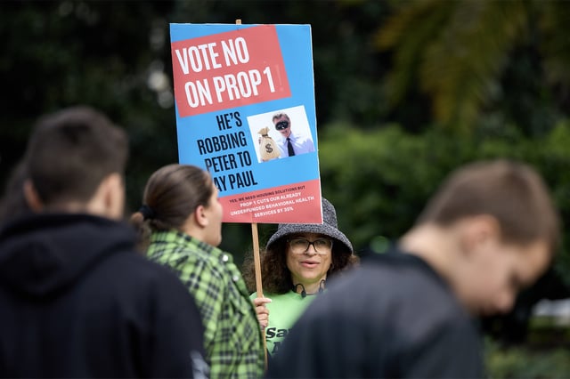 Protestor Natalie Conrad tries to engage with students on a field trip to the Capitol during a lightly attended “Vote No on Prop. 1” protest on the west steps of the Capitol on Feb. 1, 2024. Photo by Fred Greaves for CalMatters