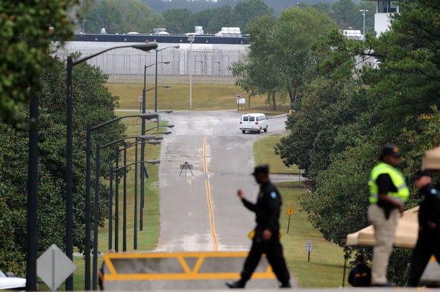 A Georgia Department of Corrections officer walks in 2011 at the entrance to the Georgia Diagnostic and Classification Prison in Jackson.