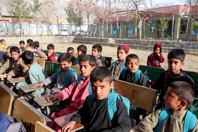 Afghan school boys attend their first class following the start of the new academic year, with girls banned for a third year running