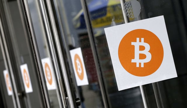 In this 2014 photo, Bitcoin logos are displayed at the Inside Bitcoins conference and trade show in New York. Because of how cryptocurrencies like Bitcoin are mined, they have unique digital identities. And that design is something law enforcement and regulators can exploit to identify people using cryptocurrencies to hide illegal activity. (AP Photo/Mark Lennihan, File)