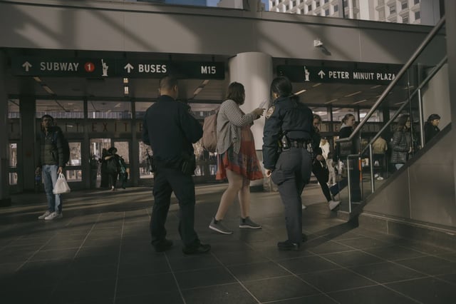 A male and female police officer patrol the subways.
